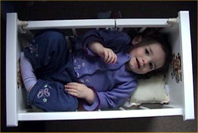 lottie in dolls' cot